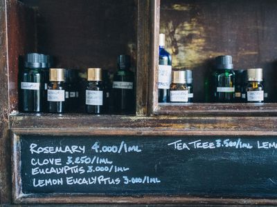 Candle and aromatherapy oils on a wooden shelf